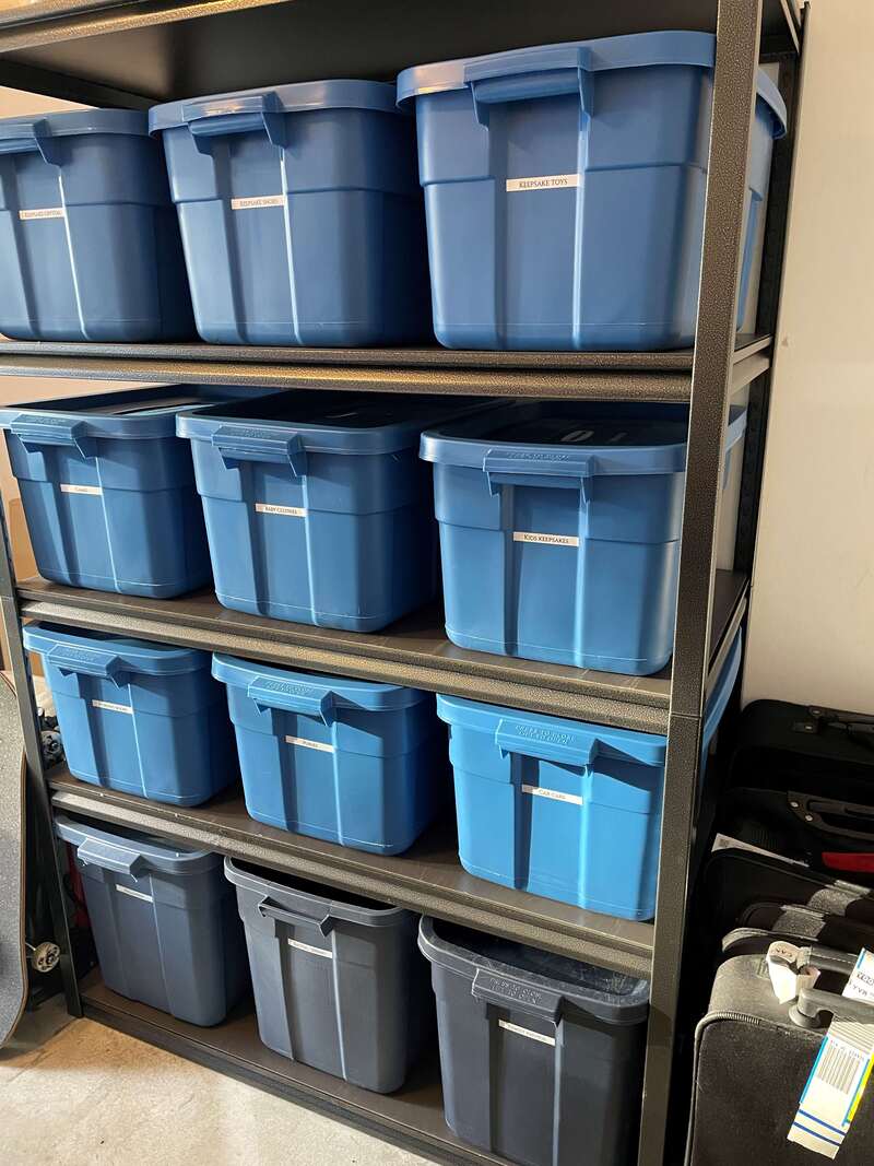 Garage storage totes organized on metal shelf